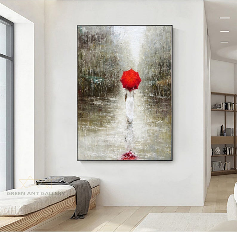 May include: A painting of a person walking in the rain with a red umbrella. The person is wearing a white dress and is walking away from the viewer. The background is a blurry cityscape.