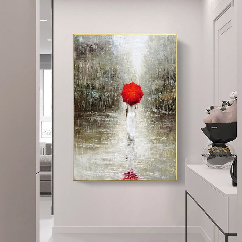 May include: A painting of a woman walking in the rain with a red umbrella. The woman is wearing a white dress and the background is a city street.