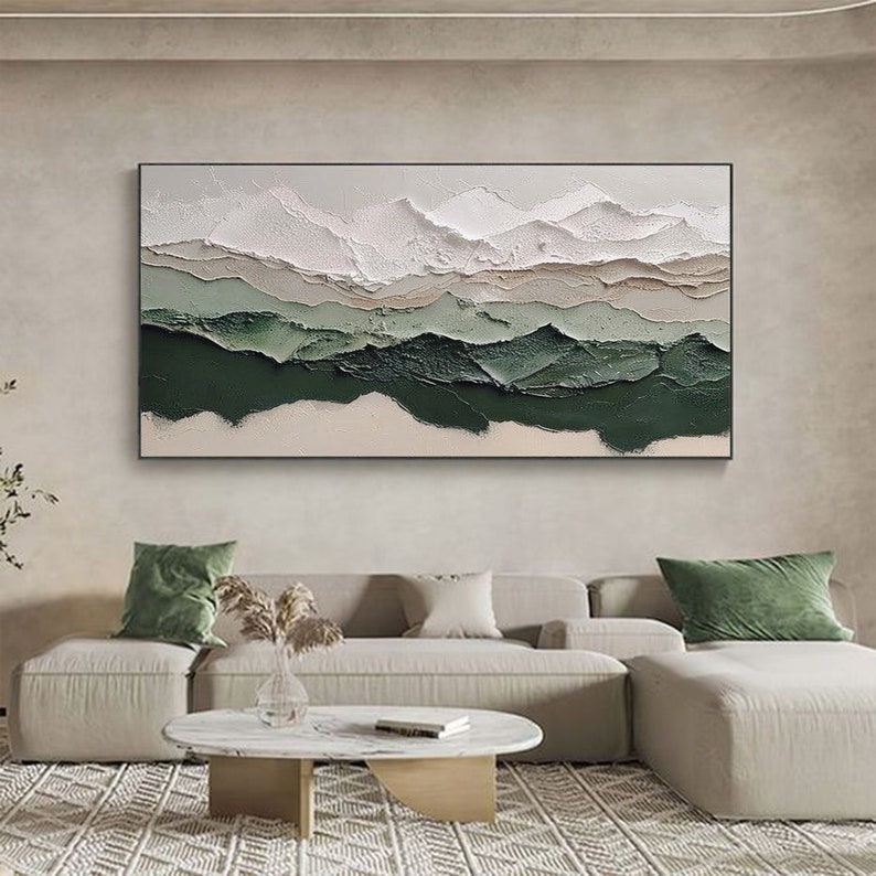 May include: Abstract landscape painting with textured layers of white, beige, and green paint. The painting depicts a series of mountains with a layered effect.