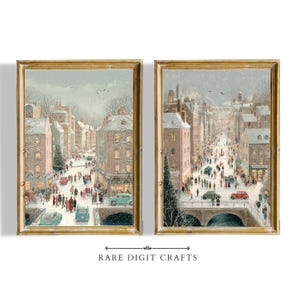 May include: Two framed prints show a snowy European town scene with people, cars, and buildings. The artwork features a bridge, Christmas trees, and a vintage aesthetic. The frames are gold-coloured, and the prints are labelled "RARE DIGIT CRAFTS".