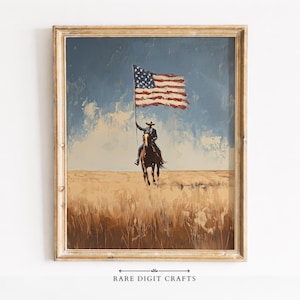 May include: Framed painting of a cowboy on horseback holding a large American flag. The artwork features a blue sky, a field of tall grass, and a gold-colored wooden frame. The text "RARE DIGIT CRAFTS" is at the bottom.