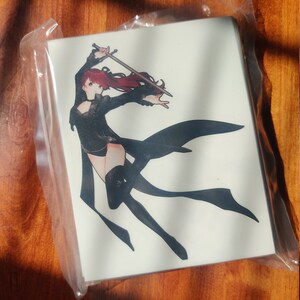 May include: A black and white illustration of a woman with red hair, wearing a black outfit and holding a sword. The woman is jumping in the air and her hair is flowing behind her.
