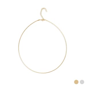 May include: A delicate gold-colored necklace with a simple, circular design. The necklace features a thin, wire-like band that forms a complete circle, with a small chain and clasp at the back for closure. The jewelry is set against a white background.