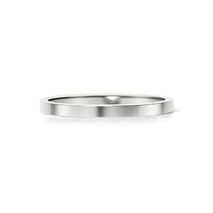 May include: A simple, silver wedding band with a flat, polished surface.