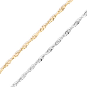 May include: Two delicate chain necklaces, one gold and the other silver, are shown against a white backdrop. The chains have a twisted rope design, creating a textured appearance. The chains are angled diagonally across the frame.