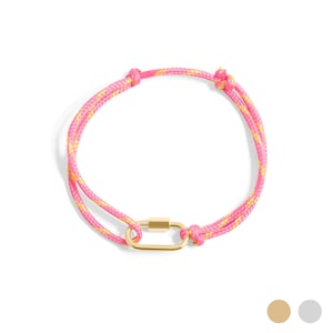 May include: A pink and yellow rope bracelet with a gold-colored clasp. The bracelet is made of a woven rope material and features a rectangular clasp in the center. The bracelet is shown on a white background.