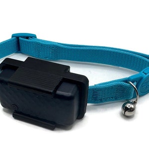 May include: A blue cat collar with a black electronic device attached. The collar has a small bell on the end.