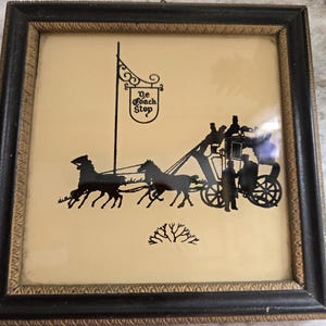 May include: A framed black and white silhouette image of a horse-drawn carriage with the text "Ye Coach Stop" on a flag.