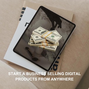 May include: A tablet computer displaying a stack of US dollar bills on a white surface. The text "START A BUSINESS SELLING DIGITAL PRODUCTS FROM ANYWHERE" is displayed below the image.