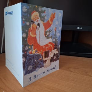 Postal doble de Ukrtelecom, telegrama en blanco de un operador telefónico ucraniano, Feliz Año Nuevo, cuadro de Zarubin, Ded Moroz y una liebre, árbol de Navidad