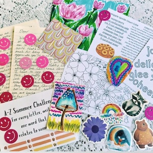 May include: A collection of stationery items including handwritten letters, a recipe card for pineapple upside-down cake, a floral coloring page, a mushroom illustration, and various stickers featuring smiley faces, a raccoon, a bear, and a rainbow.