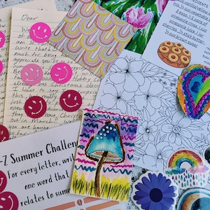 May include: A collection of stationery items including handwritten letters with pink smiley face stickers, a recipe card for pineapple upside-down cake, a rainbow pattern square, a floral coloring sheet, a watercolor mushroom, and various stickers.