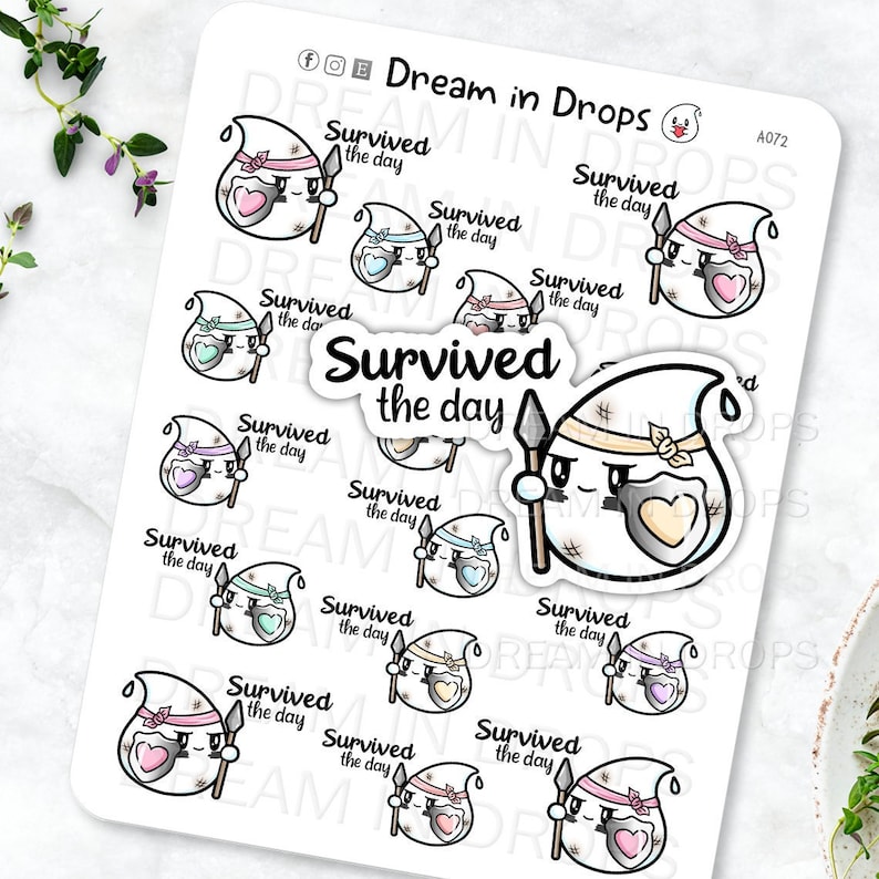 May include: A sheet of stickers featuring a cartoon ghost with a shield and spear. The ghost is wearing a bandage and has a heart on its chest. The text "Survived the day" is repeated on each sticker in different colors.