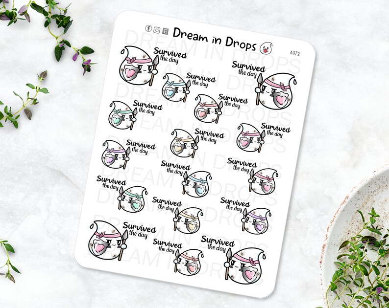 May include: A sheet of 15 stickers featuring a cartoon ghost character with a heart and a spear. Each sticker says "Survived the day". The stickers are in various pastel colors.