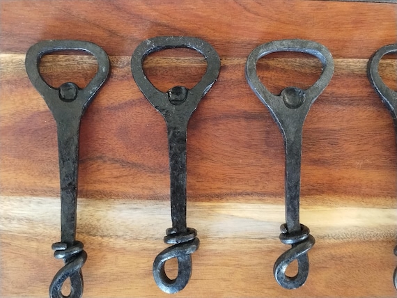 A Canadian blacksmith hammers raw steel into a functional bottle opener — every one comes out slightly different.