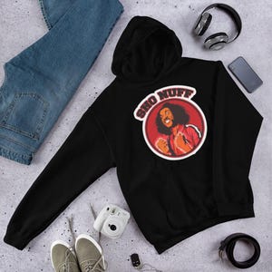 May include: Black hooded sweatshirt with a red circle graphic featuring a cartoon character and the text "Sho Nuff".