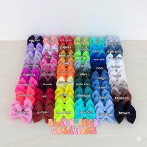 May include: A collection of colorful hair bows in various shades, including pink, blue, green, and yellow. Each bow is labeled with its color name. The text "BLACK ROCK CREATIONS" is displayed at the bottom.