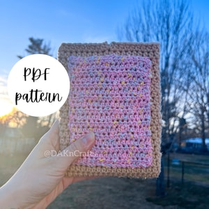 May include: A crocheted rectangular item with a pink and speckled center and a tan border. The text "PDF pattern" is in a white circle. The creator's handle, "@DAKnCrafts", is also visible.