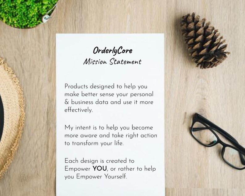 May include: A white sheet of paper with black text on a wooden surface. The text reads "Orderly Core Mission Statement" and includes a mission statement about helping people make better sense of their personal and business data.