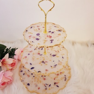 White and gold tiered cupcake stand with dried petals