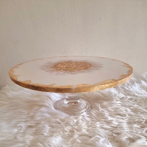 White and gold leaf cake stand with glass base
