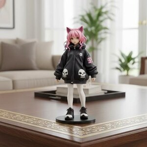 May include: A figurine of a girl with pink hair and cat ears, wearing a black jacket with skull designs and white leggings. She is standing on a black base, wearing black and white sneakers. The figurine is on a wooden coffee table.