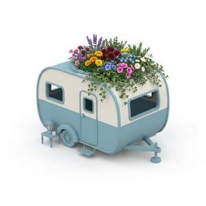 May include: A light blue and cream-coloured camper trailer planter filled with a variety of colourful flowers including red roses, yellow marigolds, purple lavender, and green ivy. A small matching side table with a lantern sits beside the camper.