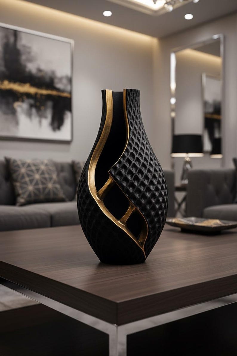 May include: A black decorative vase with a textured diamond pattern and gold accents. The vase has a unique, open design with a curved shape. This modern vase is a stylish home decor item.