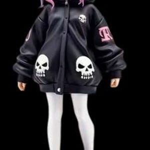 May include: A figurine of a person with pink hair and cat ears wearing a black jacket with skull designs and white leggings. The figure is standing on a black base, wearing black and white sneakers.