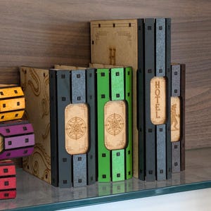 May include: A set of six wooden storage boxes with different colored fronts. The boxes are labeled with the words "Hotel", "Chance", "Community Chest", "Jail", "Free Parking", and "Go".