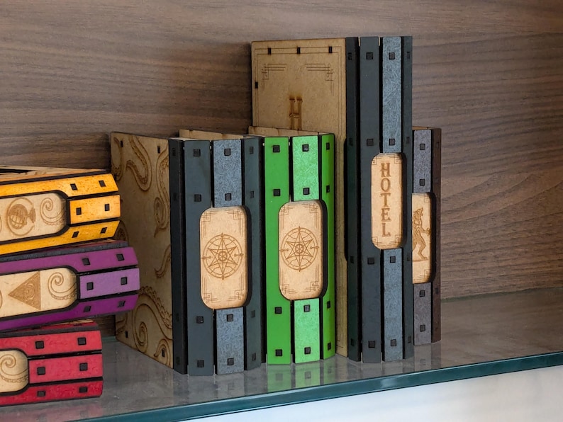May include: A set of six wooden storage boxes with different colored fronts. The boxes are labeled with the words "Hotel", "Chance", "Community Chest", "Jail", "Free Parking", and "Go".