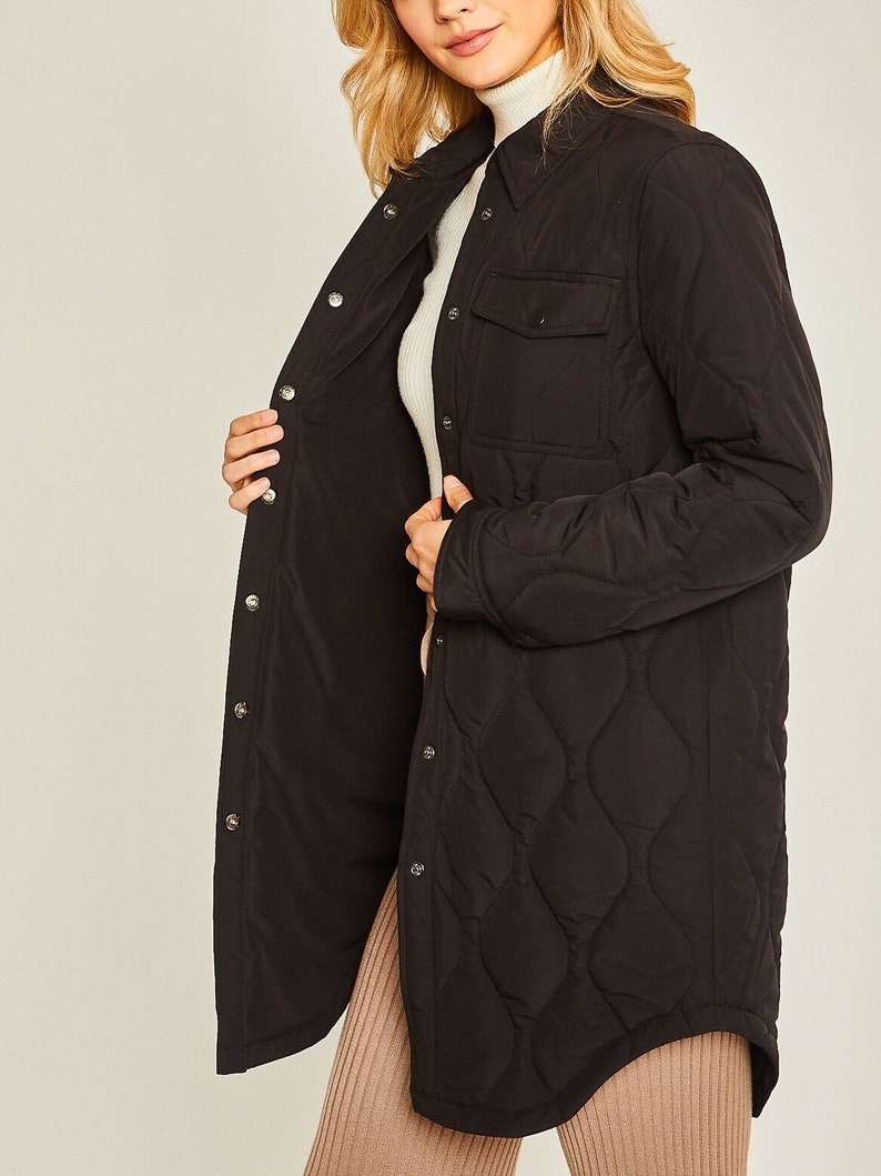 May include: A black quilted shirt jacket with a button-up front and a single chest pocket.