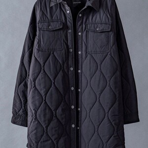 May include: A black quilted long-sleeve shirt jacket with a button-up front and two flap pockets. The jacket has a diamond-shaped quilting pattern.