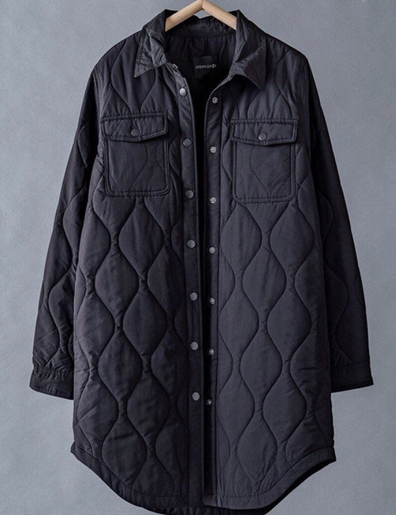 May include: A black quilted long-sleeve shirt jacket with a button-up front and two flap pockets. The jacket has a diamond-shaped quilting pattern.
