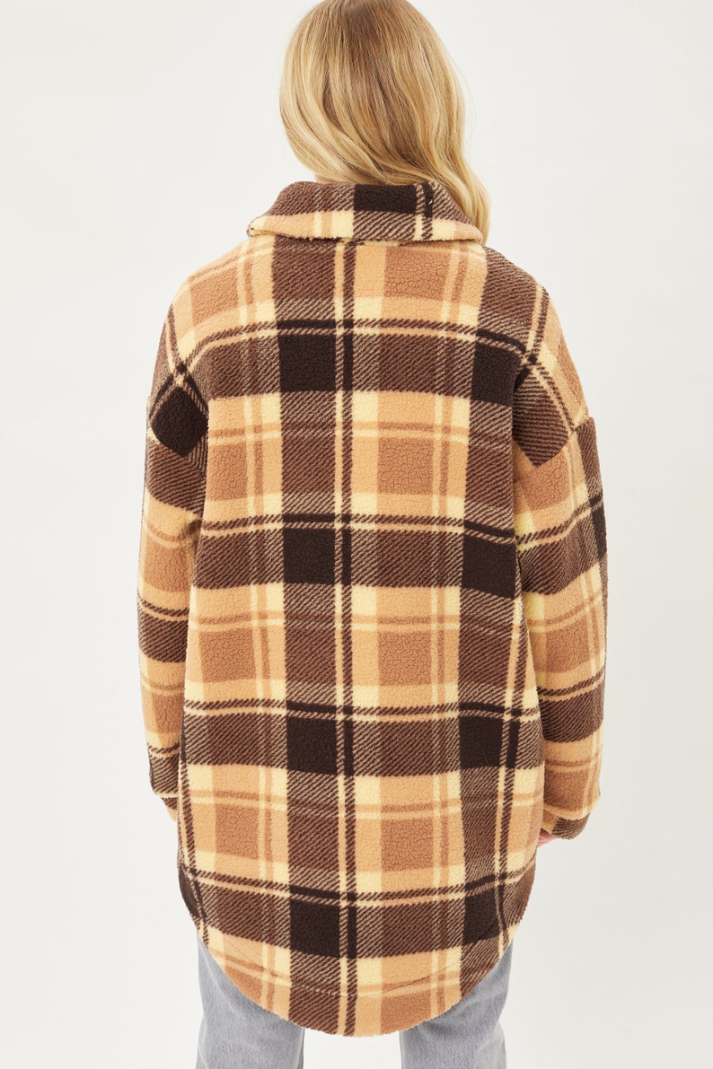 May include: A brown and cream plaid fleece jacket with a long, relaxed fit.