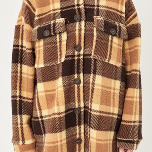 May include: A brown and beige plaid sherpa jacket with a button-up front.