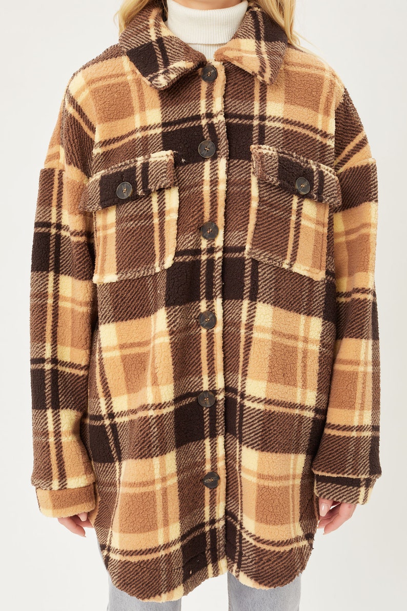 May include: A brown and beige plaid sherpa jacket with a button-up front.