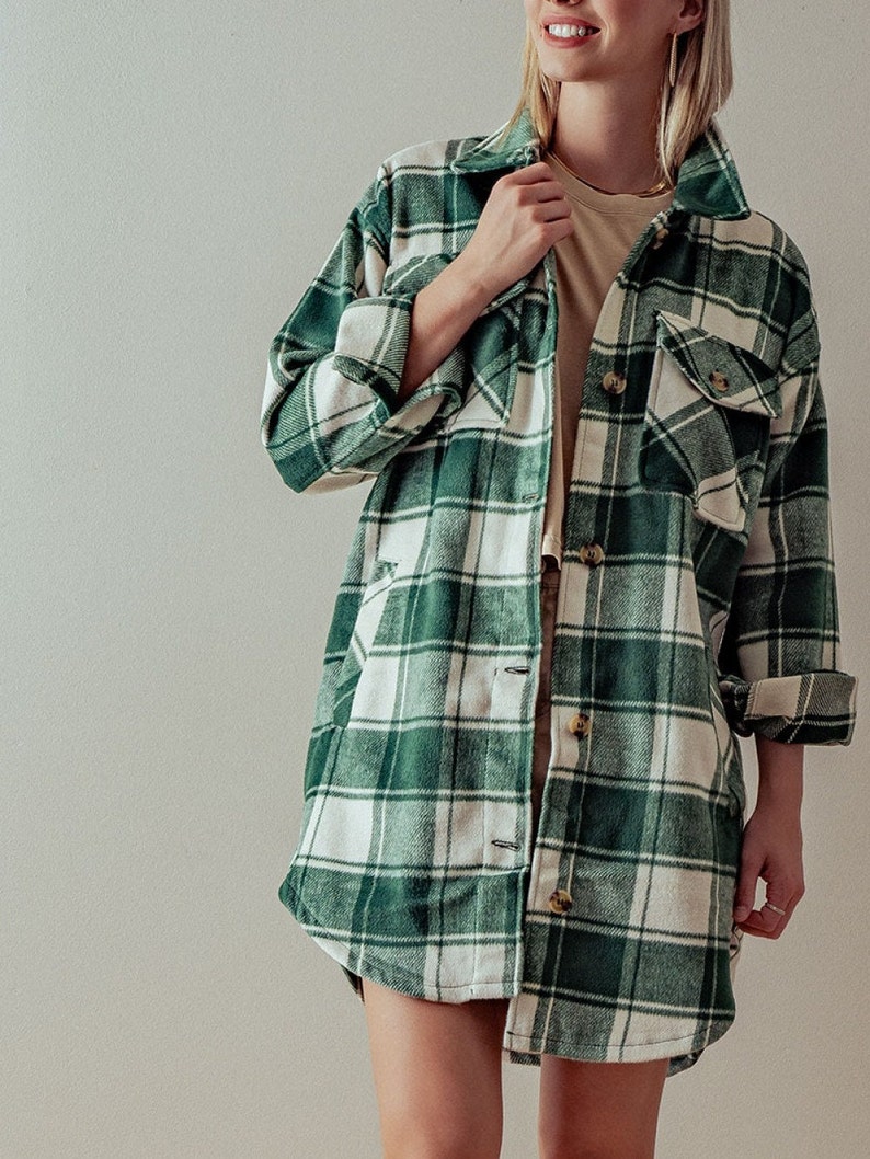 Puede incluir: Una camisa de franela a cuadros verde y blanca con mangas largas y cierre de botones.