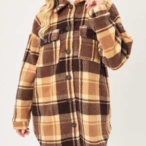 May include: A brown and beige plaid sherpa jacket with a button-up front and long sleeves.