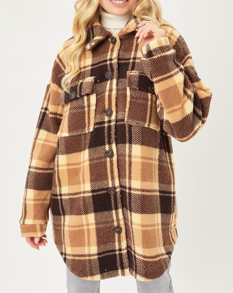 May include: A brown and beige plaid sherpa jacket with a button-up front and long sleeves.
