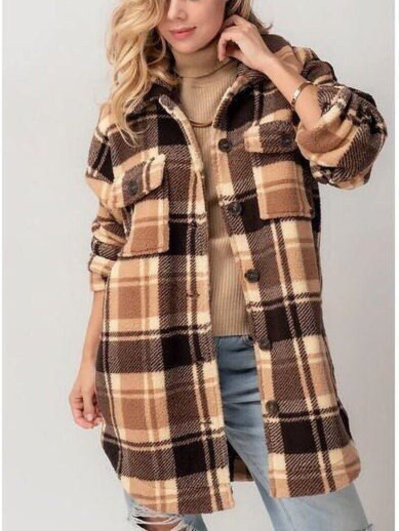 May include: A long-sleeved brown and white checked flannel shirt jacket with a button-up front and two large pockets.