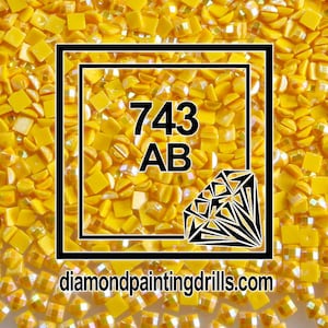 May include: Close-up of a yellow diamond painting drill with the number 743 AB and the website diamondpaintingdrills.com.