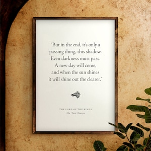 May include: A framed print with a quote from "The Lord of the Rings: The Two Towers" by J.R.R. Tolkien. The quote reads: "But in the end, it's only a passing thing, this shadow. Even darkness must pass. A new day will come, and when the sun shines it will shine out the clearer."