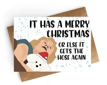 May include: A Christmas card with a white background and blue glitter. The card features a cartoon image of a man with a shocked expression holding a white dog wearing a Santa hat. The text on the card reads "It has a merry Christmas or else it gets the hose again."