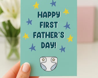 May include: A teal Father's Day card with the text "HAPPY FIRST FATHER'S DAY!" in white and blue. The card features yellow and blue stars and a diaper illustration.