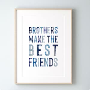 以下が含まれることがあります： 青の色合いで「BROTHERS MAKE THE BEST FRIENDS」という文字が描かれた額装されたウォールアートプリント。文字は白い背景にテクスチャのある筆致で表現されており、明るい色の木製フレームに収められています。
