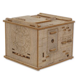 May include: A wooden box with a complex locking mechanism. The box has a circular dial with numbers and symbols, a sliding panel, and a small hole in the front. The box is made of light brown wood and has a rustic appearance.