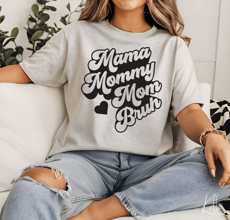 May include: A gray t-shirt with a retro-style graphic that says "Mama Mommy Mom Bruh" in black text.