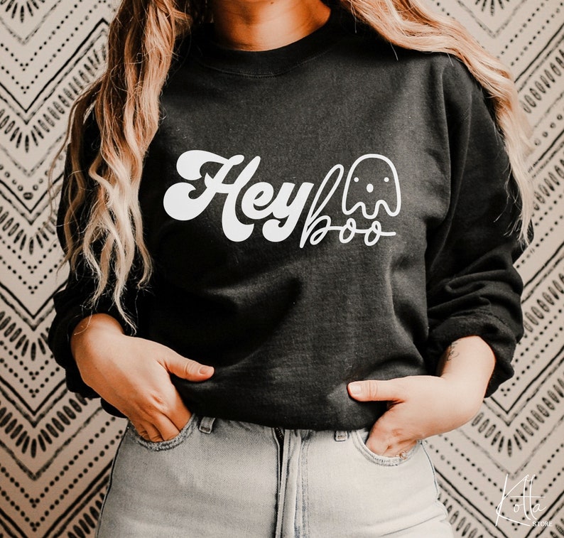May include: Black sweatshirt with a white graphic that says "Hey Boo" with a ghost illustration.