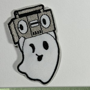 May include: White embroidered ghost with a black outline wearing a silver and black boombox on its head.